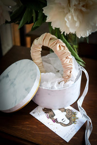 Luxury hardcover hat box used for shipping the Jenna light beige silk headband.