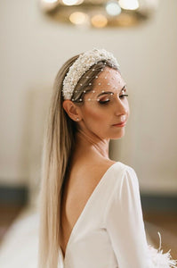 Discover the Luna Wedding Headpiece: A masterpiece of elegance handcrafted with freshwater pearls, Swarovski crystals, and Italian luxury silk. Embrace timeless beauty for your special day.